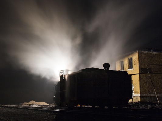 An 0-8-0 C2 steam locomotive of the Huanan Forestry Railway waits in Lixin long before sunrise on September 29, 2005.