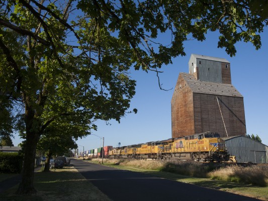 Union Pacific container train north passing the soon-to-be-demolished grain elevator in Halsey, Oregon, on July 16, 2010.