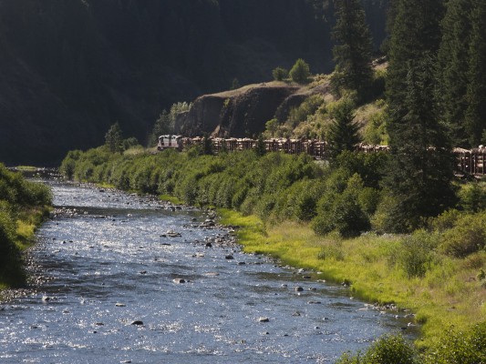 The St. Maries River glistens in the late afternoon sun as the St. Maries River Railroad's inbound Clarkia Logger rolls toward St. Maries, Idaho, in July 2005.