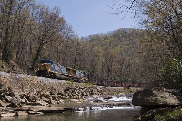 An eastbound loaded coal train on CSX's Cowen Subdivision runs along Laurel Creek just north of Erbacon, West Virginia, on a clear spring day in 2004.