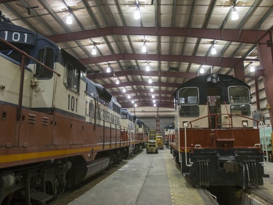 St. Maries River Railroad's entire roster of five locomotives—three GP9s and two SW1200s, all former Milwaukee Road—rest in the railroad's three-track shop in St. Maries, Idaho, at the end of an October day in 2008.