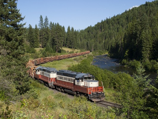 The St. Maries River Railroad's inbound Clarkia logger is deep in the canyon of its namesake in July 2004, bringing a trainload of logs from the Clarkia reload to the Potlatch mill in St. Maries.