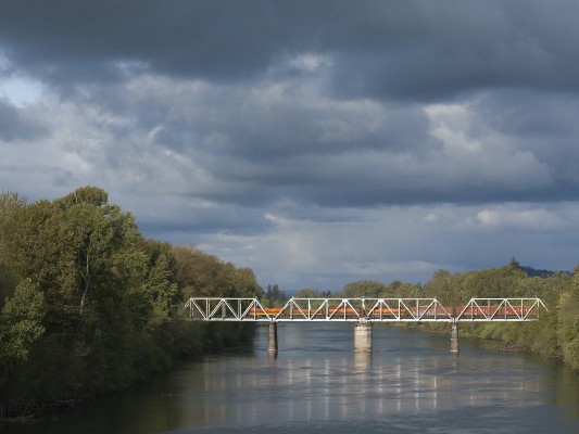 Spring clouds roll above the Willamette River in Albany, Oregon, as Portland and Western's Toledo Hauler leaves town in the late afternoon of April 25, 2009.