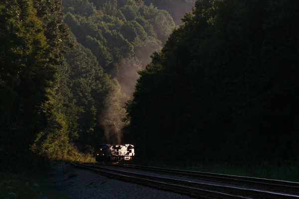 The setting sun provides a spotlight for an eastbound CSX loaded coal train climbing Newburg Grade at Tunnelton, West Virginia.