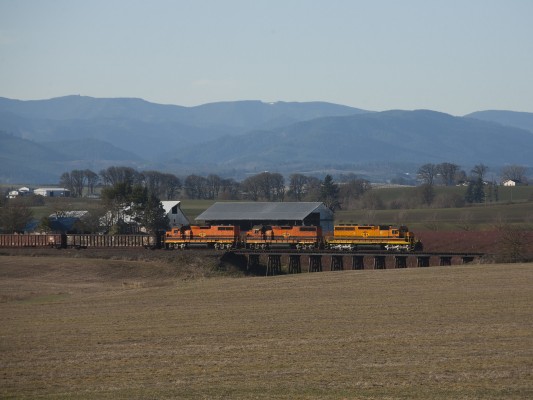 Portland and Western's Westsider freight train crosses a short trestle near McMinnville, Oregon, on December 2, 2009, as the Coast Range Mountains loom in the background.