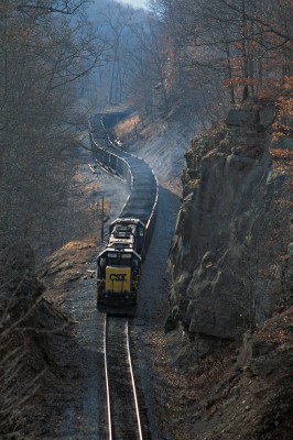 On CSX's remote Cowen Subdivision in March 2001, two SD60s lead a unit coal train upgrade near Frenchton, West Virginia, and through a large rock cut before entering French Hill Tunnel, the vantage for this view.