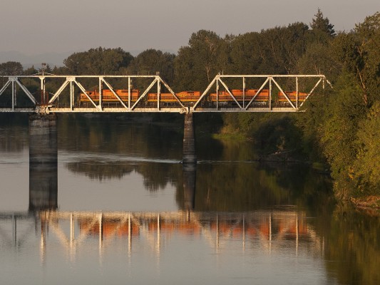 Just before sunset on September 14, 2008, Portland and Western's Toledo Hauler crosses the Willamette River in Albany, Oregon, at the start of the train's nocturnal run to Toledo and back.