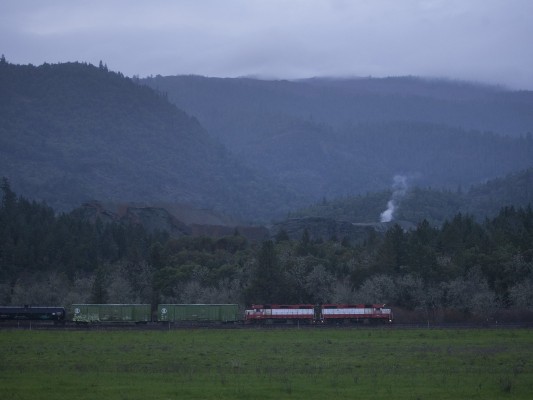 While it looks like this Central Oregon and Pacific Railroad freight train could be passing an active volcano, it is in fact a sand mine just outside of Riddle, Oregon.