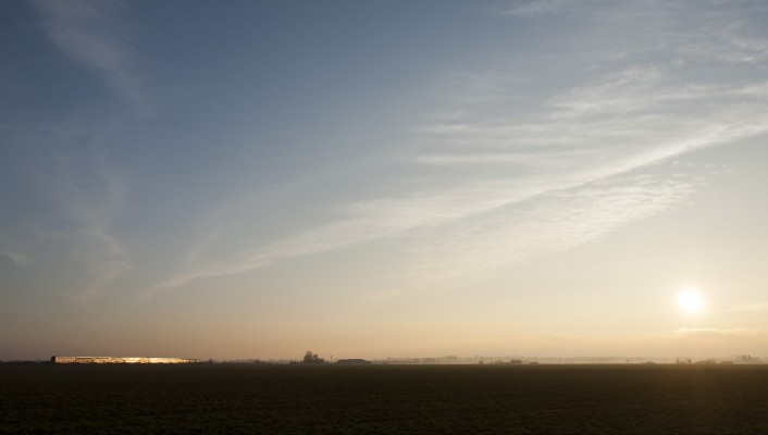 Amtrak's <i>Coast Starlight</i> passenger train no. 11 glints as the sun sets over the Willamette Valley near Harrisburg, Oregon, on February 7, 2009.
