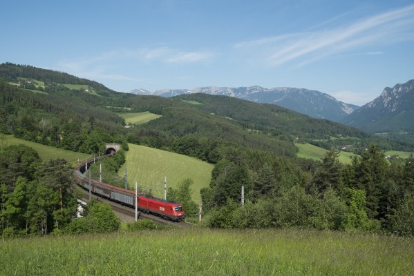 Southbound freight train climbing the 2.5-percent grade near Eichberg, through the foothills just south of the Schwarza River. Payerbach, shown in the opposite photograph, is in the notch in the valley at far right in this view. While most freight trains on the Semmering have two or three locomotives, a single EuroSprinter (Seimens, 8,600 horsepower) is adequate for this lightweight train of empty boxcars.