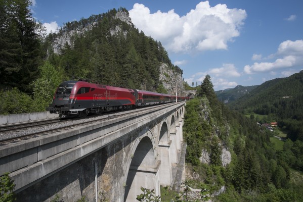 An afternoon Railjet passenger train bound for Graz crosses Krauselklause Viaduct above Breitenstein.