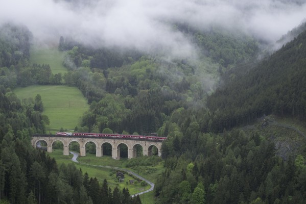 A RailJet passenger train for Graz crosses Adlitzgraben Viaduct on a misty May morning.