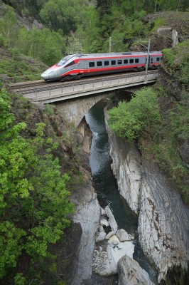 EuroCity train from Milan to Zurich crossing the Ticino River in the middle of the Piottino Gorge.