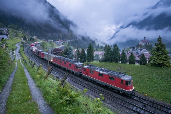 As low clouds roll up the Reuss Gorge at Wassen, Switzerland, a container train heads north behind two workhorses of the Swiss Federal Railways.