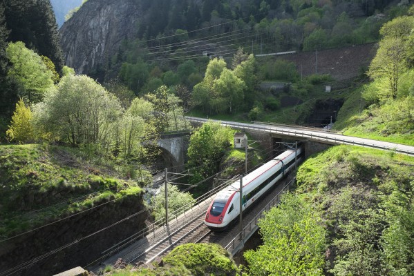 ICN passenger train south in the Piottino Gorge. In mid-May the sun sets directly in line with narrow gorge.