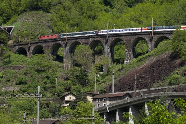 InterRegio passenger train north crossing the Piano Tondo Viaduct while climbing the dual spirals at Biaschina.