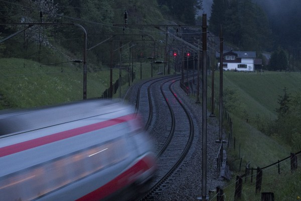 The last car of EuroCity 22 streaks north through Wassen on its way from Zurich to Milan. The former lineman's house in the background is now a private residence.