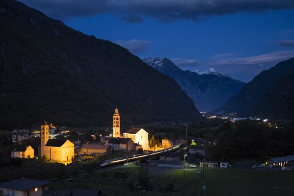 Twilight gathers around Giornico, Switzerland, as EuroCity passenger train no. 25 heads south on its run from Zurich to Milan.