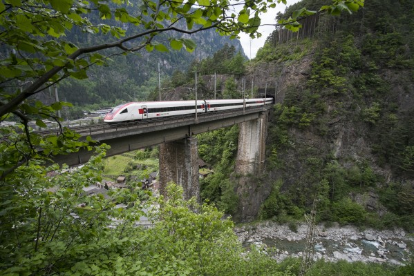 ICN passenger train 873  from Zurich to Lugano crosess the Chärstelenbach Bridge at Amsteg. The steel girders replaced an earlier (and much better-looking) deck truss structure.