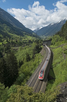 With clouds shrouding Gotthard Pass in the background, ICN 672 from Lugano to Basel rolls downgrade approaching the Pfaffensprung Spiral Tunnel just north of Wassen.