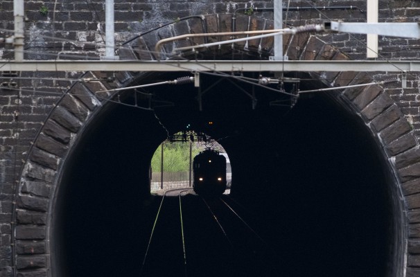 An InterRegio passenger train north enters the Dazio Tunnel just below Rodi-Fiesso.