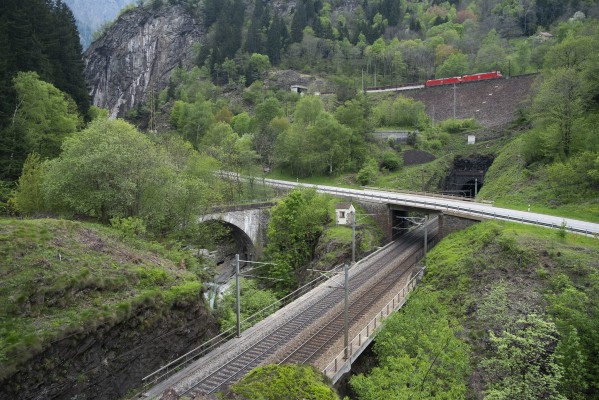 Two German electrics lead a freight south in the Piottino Gorge; the train is about to enter the Freggio spiral tunnel and will pass the tracks in the foreground in about two minutes.