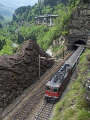 An InterRegio passenger train north climbs the grade between Faido and Rodi-Fiesso; the train is about to enter the Freggio spiral tunnel.