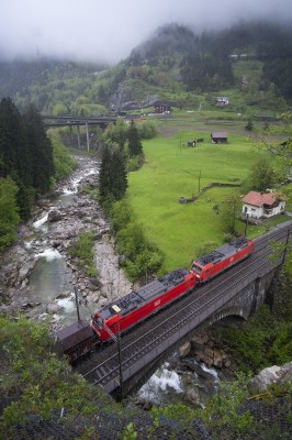 Deutsche Bahn electrics lead a mixed freight north out of the Wattingen Tunnel and across the River Reuss.