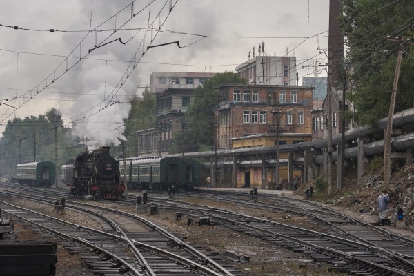 After bringing a passenger train into the Hegang station, the SY-class locomotive runs around to the other of the train in preparation for departure.