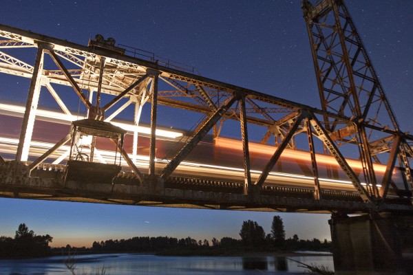 Portland and Western's OE Express crosses the Willamette River on the Oregon Electric District between Harrisburg and Junction City, Oregon, at twilight on July 30, 2008.