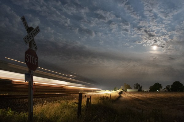 Amtrak <i>Cascades</i> train no. 509 rolls south in Oregon's Willamette Valley under a full moon on July 14, 2008.