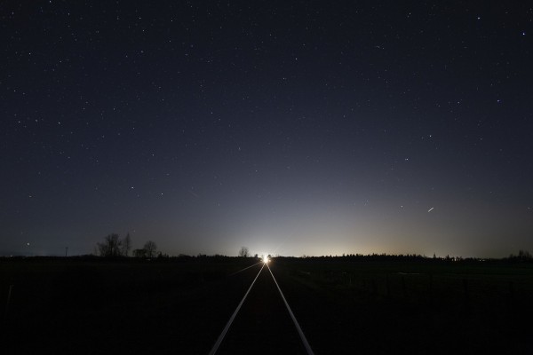 Stars shine through a clear night in the Willamette Valley near Shedd, Oregon, as Amtrak <i>Cascades</i> train no. 507 approaches on January 18, 2009.