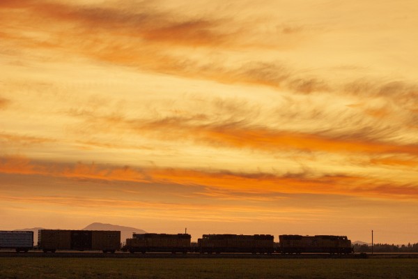 Union Pacific Railroad mixed freight train north rolling through western's Oregon's Willamette Valley at sunset on August 14, 2008, with Marys Peak in the background.