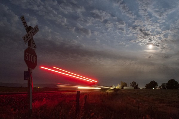 Amtrak <i>Cascades</i> train no. 509 rolls south in Oregon's Willamette Valley under a full moon on July 14, 2008.