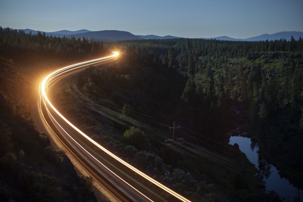 The rear locomotive of a southbound Union Pacific freight train leaves a trail of lights along the Williamson River near Kirk, Oregon, on the night of July 6, 2009.