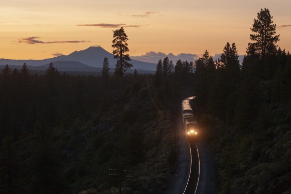Amtrak's <i>Coast Starlight</i> passenger train rolls south just after sunset near Kirk, Oregon, beneath 8,934-foot Mt. Scott on July 8, 2009.