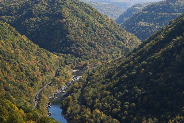 CSX westbound empty coal train with 150 cars rolls through the New River Gorge near Nuttallburg, West Virginia, on a clear October day in 2007.