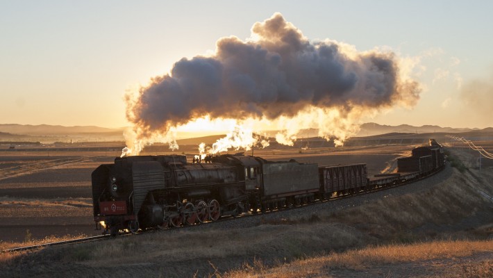 Just after sunrise on October 2, 2005, QJ 2-10-2 steam locomotive no. 7002 leads a westbound freight train up the grade out of Chabuga, Inner Mongolia, China, on the Jitong Railway. This was the first train I saw on the Jitong Line--the first of fifteen I'd see during 12 hours at trackside that day, and they were all steam-powered.