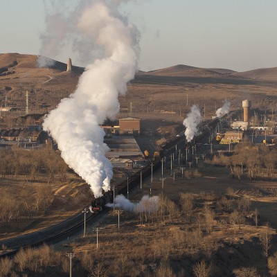 Steam from an eastbound freight train curls around the 700-year-old pagoda in Lindong, Inner Mongolia, China, on a November morning in 2005.