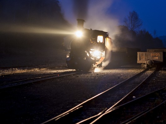 Narrow-gauge 0-8-0 C2 steam locomotive 04 of the Huanan Forestry Railway prepares to take a loaded coal train west out of Lixin, Heilongjiang, China, early in the morning of September 29, 2005.