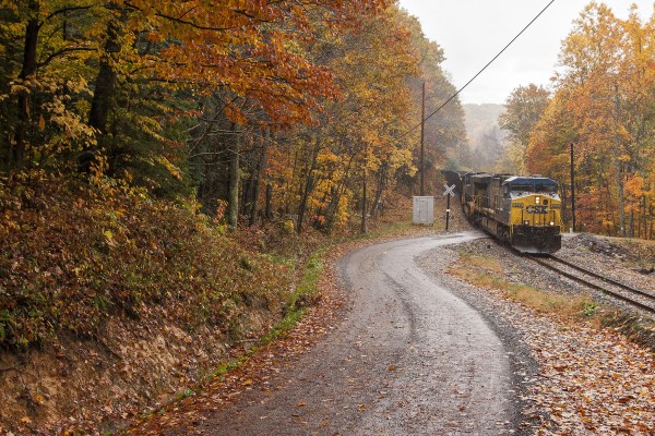 CSX's Green Valley Shifter taking empty hoppers to a mine on the former Nicholas, Fayette & Greenbrier Railroad on a peak fall day in central West Virginia near the town of Bellburn.