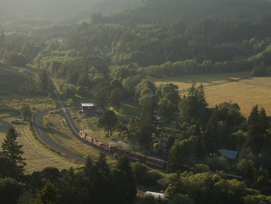 Portland and Western's Toledo Hauler freight train rolls west into the Coast Range Mountains at Harris, Oregon, as the shadows grow long on the evening of June 26, 2009.