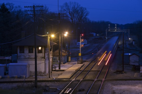 There's a Santa and snowflakes in the window of the Rondout tower as twilight falls on December 8, 2011 and inbound Metra Milwaukee North Line train no. 2146 heads for Chicago.