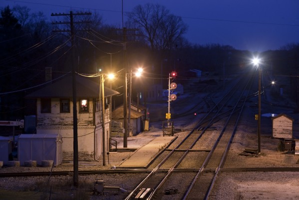 There's a Santa and snowflakes in the window of the Rondout tower as twilight falls on December 8, 2011 and outbound Metra Milwaukee North Line train no. 2125 approaches from the south.
