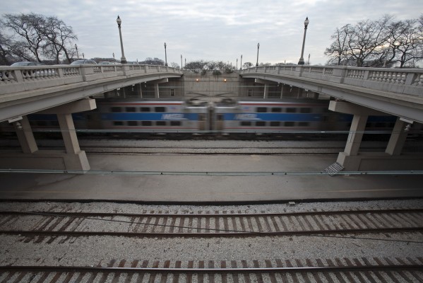 Framed by the East and West Congress Parkway overpasses, a Metra Electric commuter train parks on a siding at Van Buren Street station after its inbound morning rush hour trip on December 8, 2011.