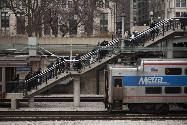 Morning commuters exit Metra's Van Buren Street Statoin as their inbound train departs on December 8, 2011.