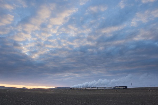 At dawn of a November day in 2005, the Jitong Railway's eastbound local passenger train steams through the fields approaching Tianshan, Inner Mongolia, China.