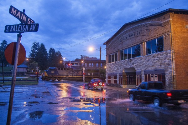 CSX loaded coal train passing the New River Company Store building in Mount Hope, West Virginia, at dawn of a wet October day in 2007.