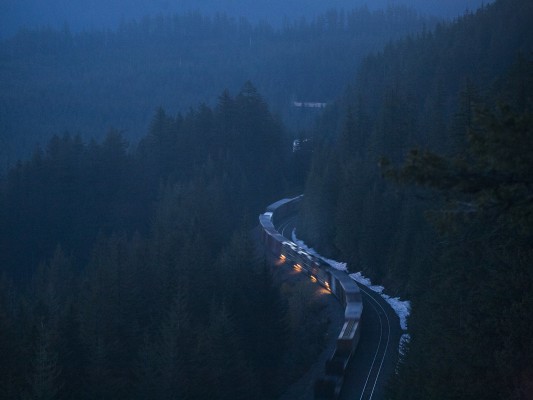 Distributed power units cut into Union Pacific's Eugene to Roseville freight train (symbol QPWRV) with 96 cars climbing the Cascade Mountains at Cruzatte, Oregon, at dawn on May 23, 2009.