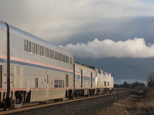 Amtrak's <i>Coast Starlight</i> passenger train no. 11 rolls south near Tangent, Oregon, as the evening sun breaks through heavy clouds on February 9, 2009.